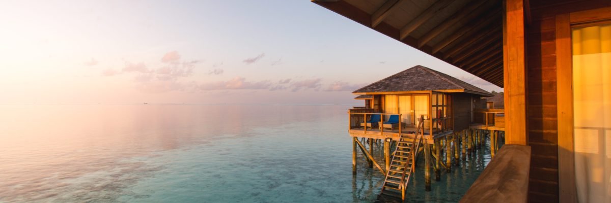 Beautiful tropical Maldives resort hotel and island with beach and sea on sky sunset for holiday vacation background concept - Boost up color Processing.